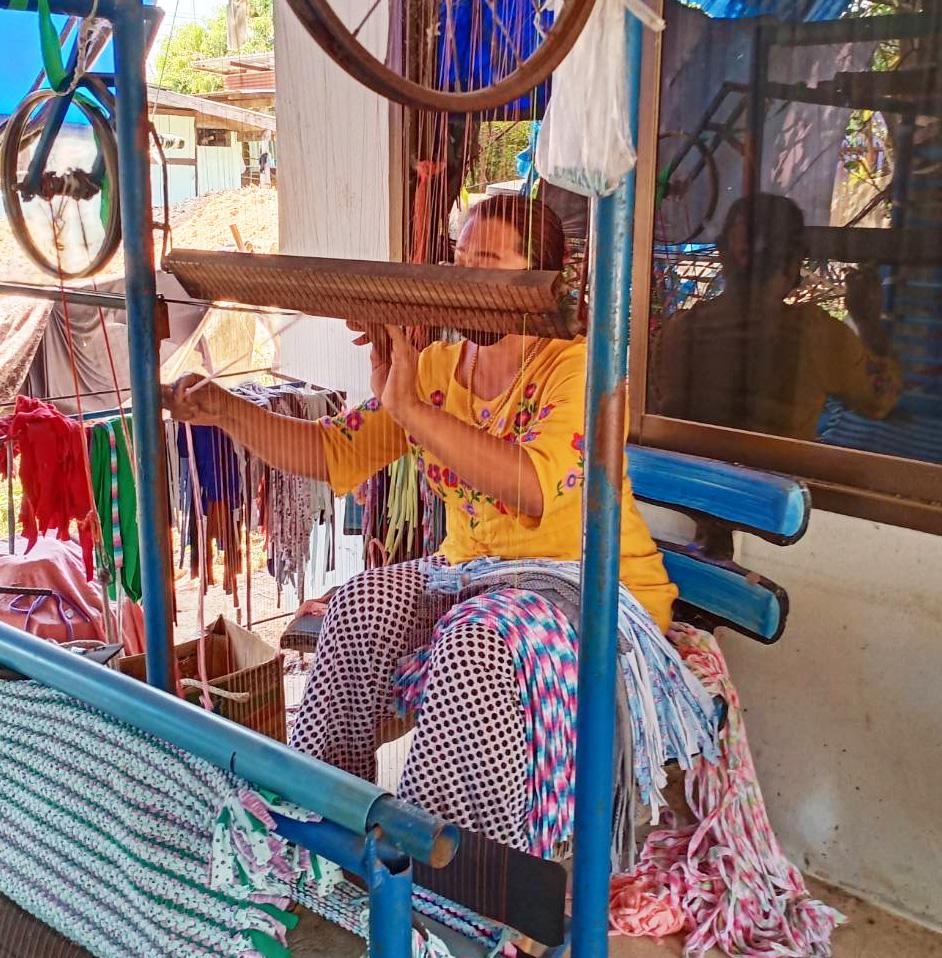 Thai woman working at a loom.