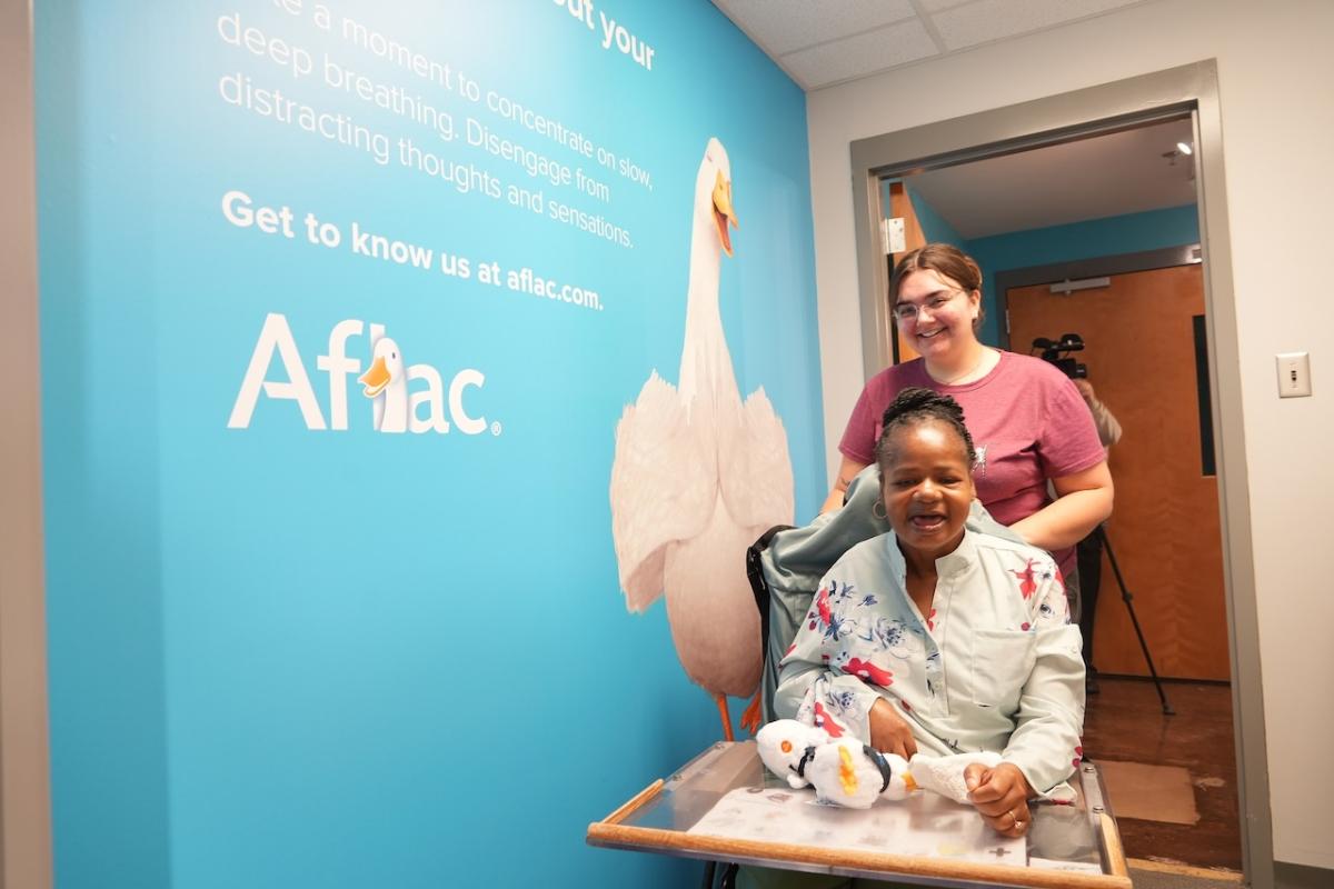 Harriet Gallman (front) and Montana Crosby, a recreation specialist with the Department of Disabilities and Special Needs, visit the new Aflac Wellness Room at the South Carolina State Museum.
