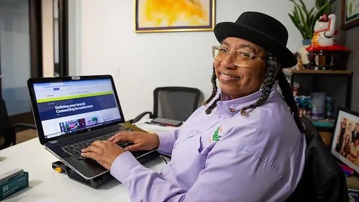 Helen Mathis working on a laptop