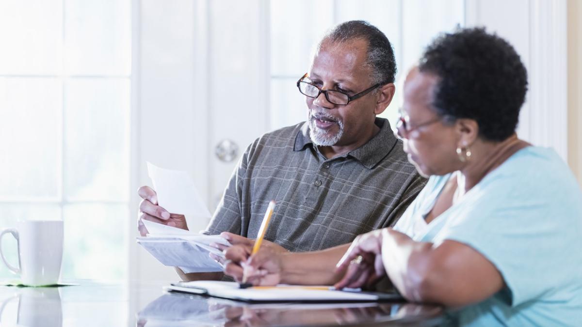 two people looking over bills at table