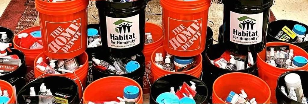 Stacked containers labelled with Home Depot and Habitat for Humanity.