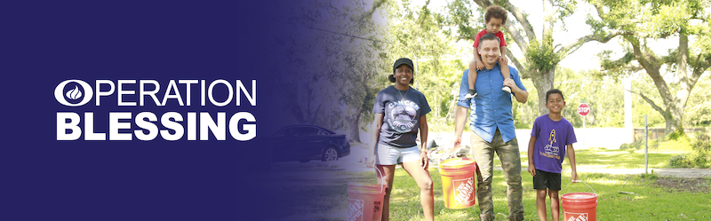 The Home Depot Operation Blessing. Family shown carrying orange buckets.