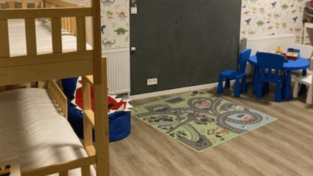 bedroom with bunk beds and a small table with chairs