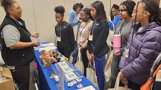 TOP PHOTO: Homewood Science Center’s 2024 Girls STEAM Celebration, held in mid-April, drew students from 24 middle and high schools from the greater Chicago area. A group of students stood at an event stand