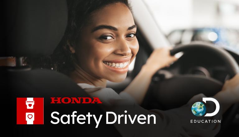 A person sat in the drivers seat looking over their shoulder