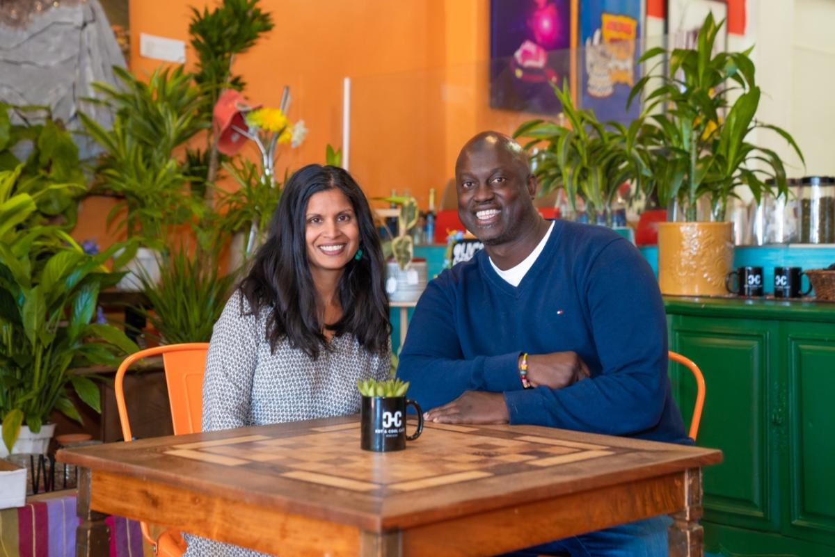 Husband and wife business owners sit at a table in their vegan cafe in Los Angeles. Husband and wife business owners sit at a table in their vegan cafe in Los Angeles.
