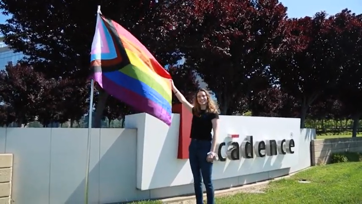 Francie Huebner holding a pride flag