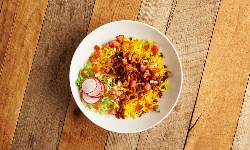 Vegan chorizo bowl on a wooden table