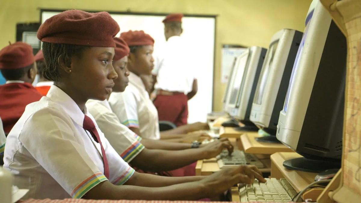 students in school uniforms at computers