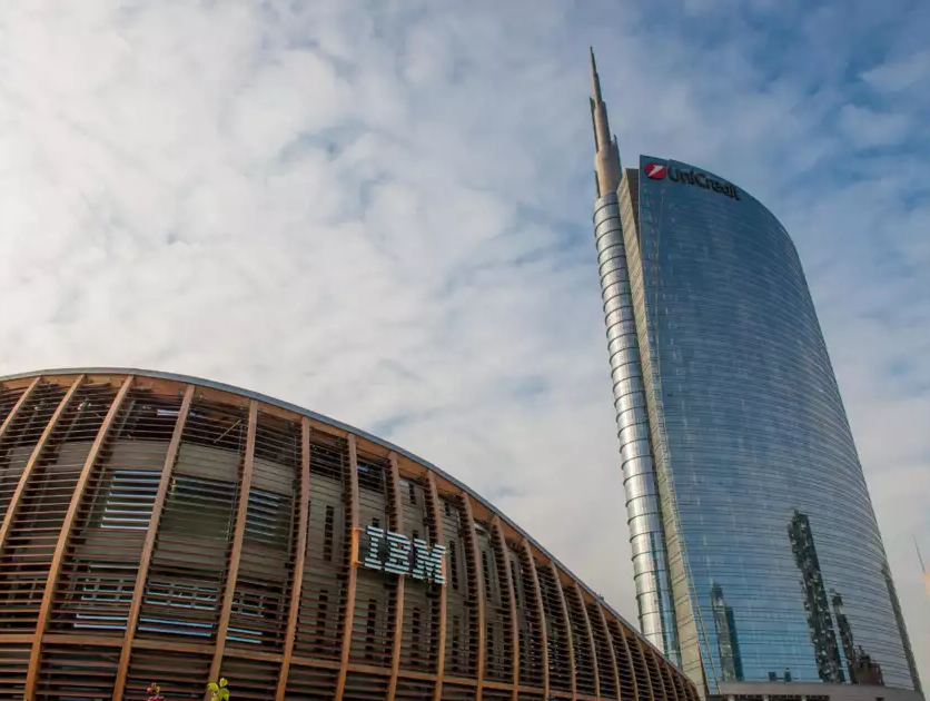 Exterior of a building with "IBM" on the side. A tall skyscraper behind it.