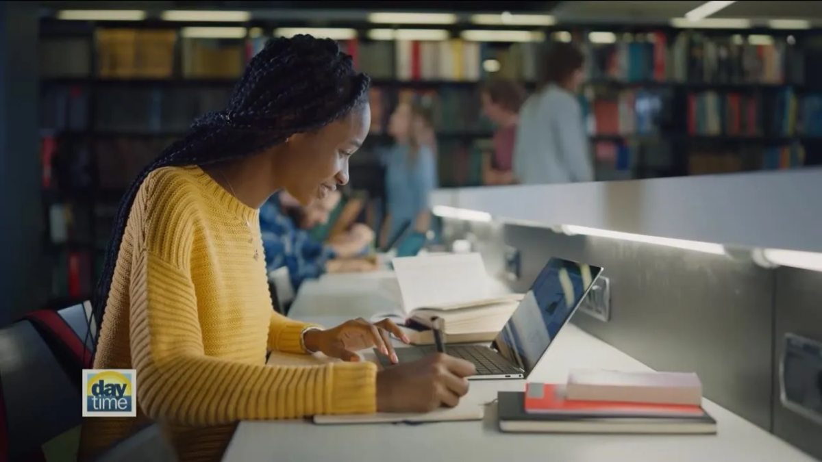 Woman sitting in front of laptop in library