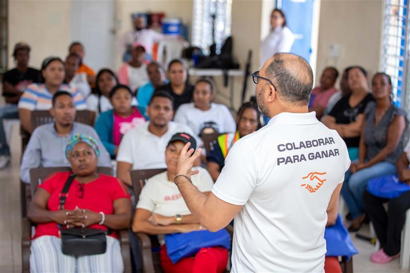 Instructor leading a financial literacy and mentorship session for community members in the Dominican Republic.