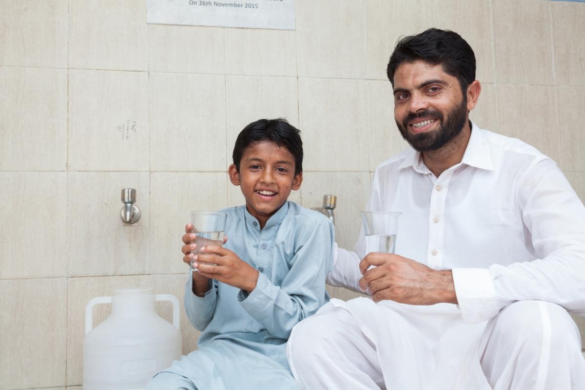 Ammar and his father are benefiting from a facility that we built to provide people with free access to clean drinking water, near our factory in Kabirwala
