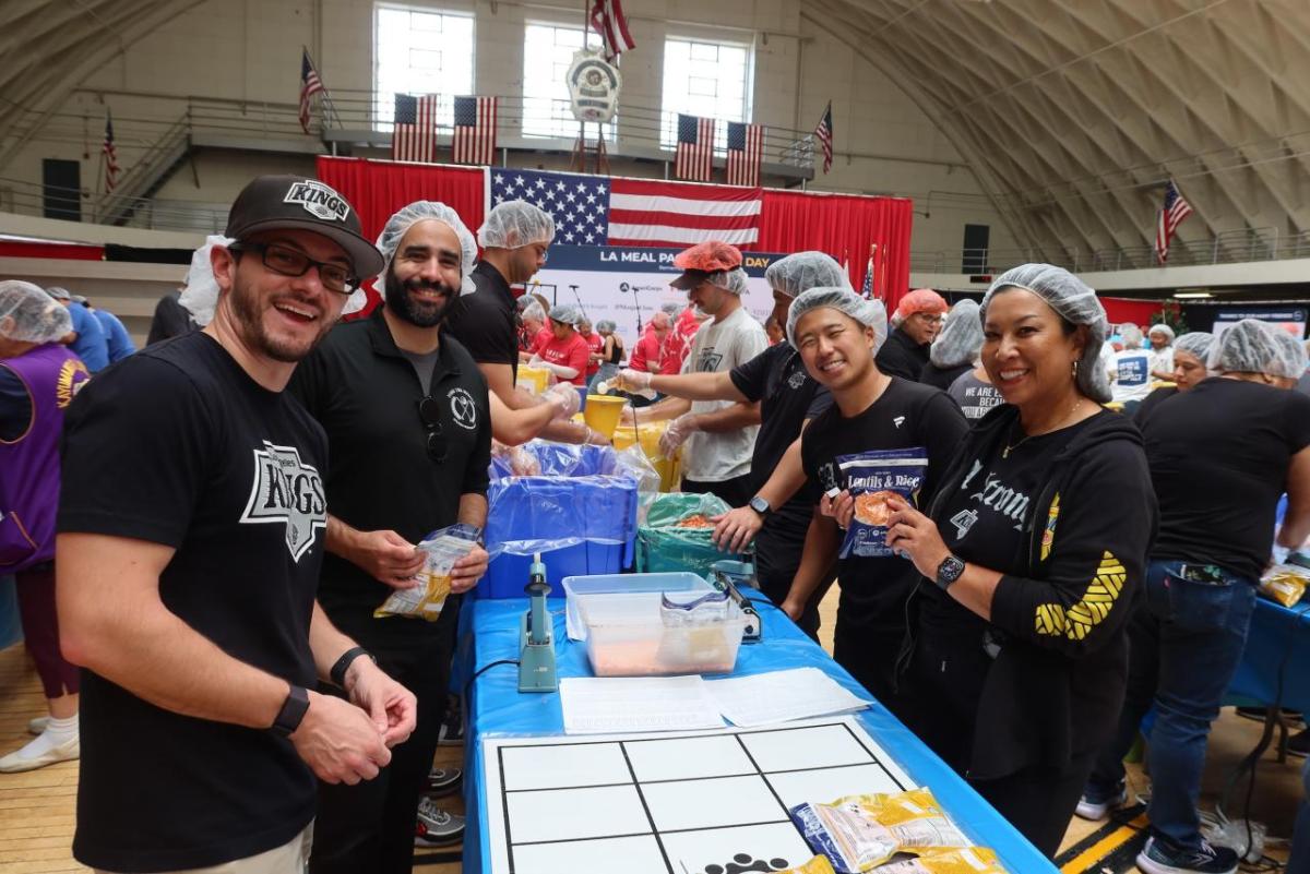 Volunteers from the LA Kings smiled as they packed meals for families in need.