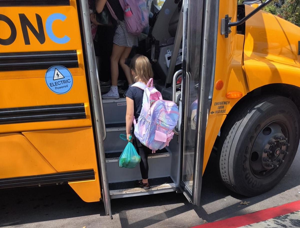 Child boarding electric bus with produce Child boarding electric bus with produce