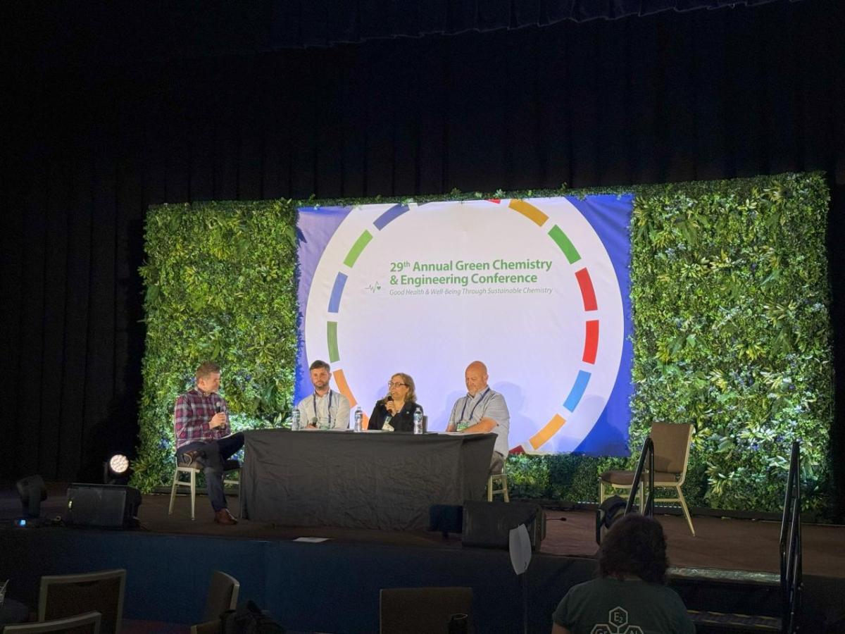 Four professionals on stage at the Annual Green Chemistry and Engineering Conference