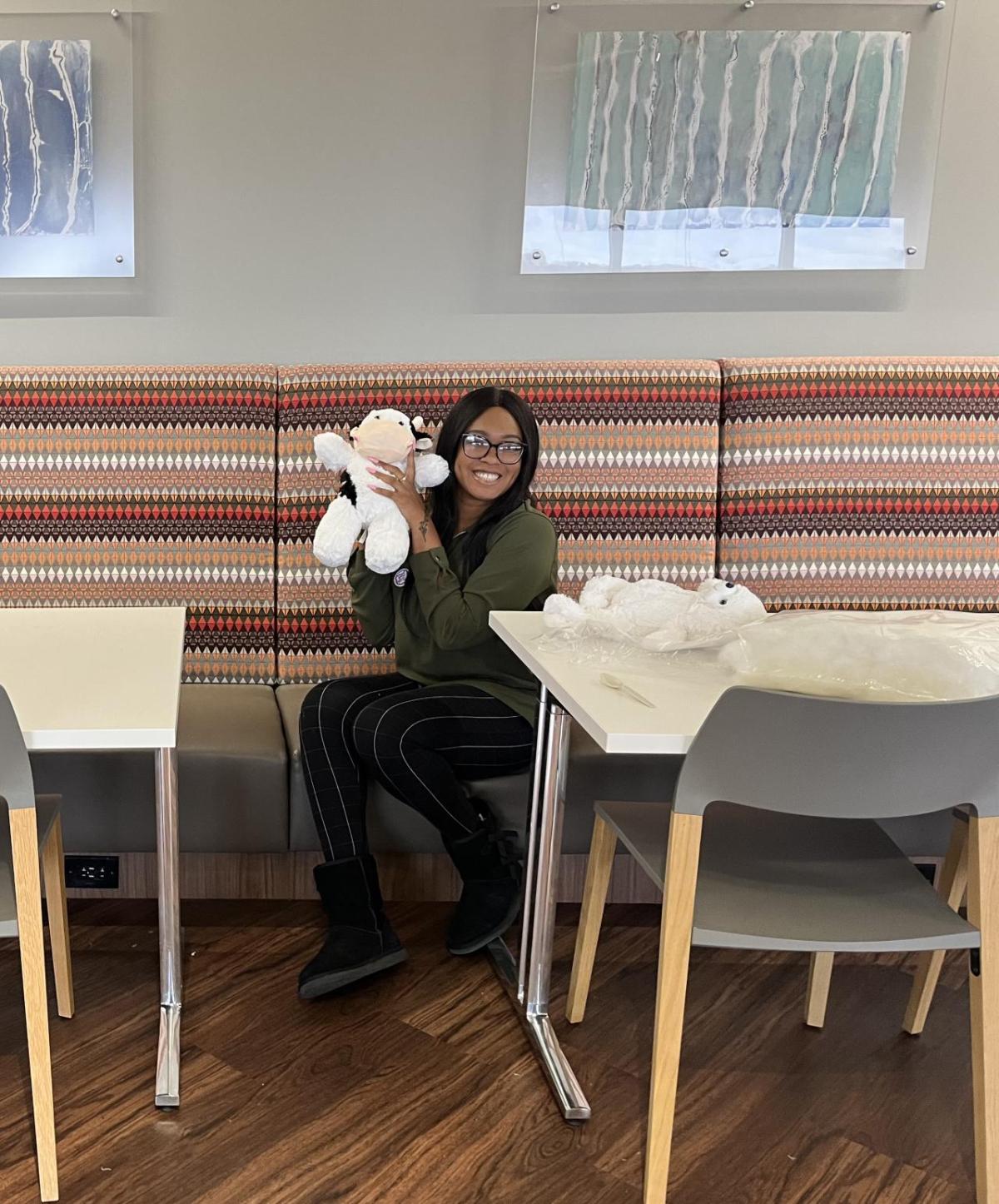 Covia employee poses with teddy bear for charities and hospitals