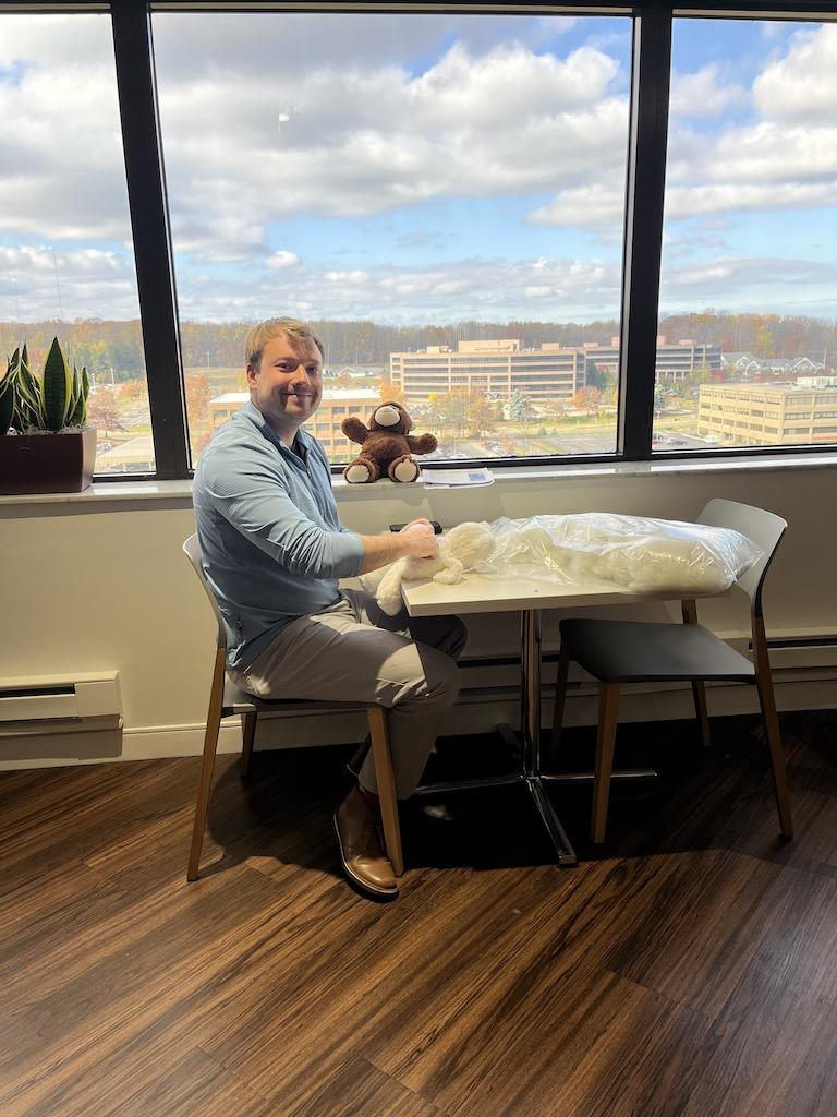 Covia employee poses with teddy bear for charities and hospitals