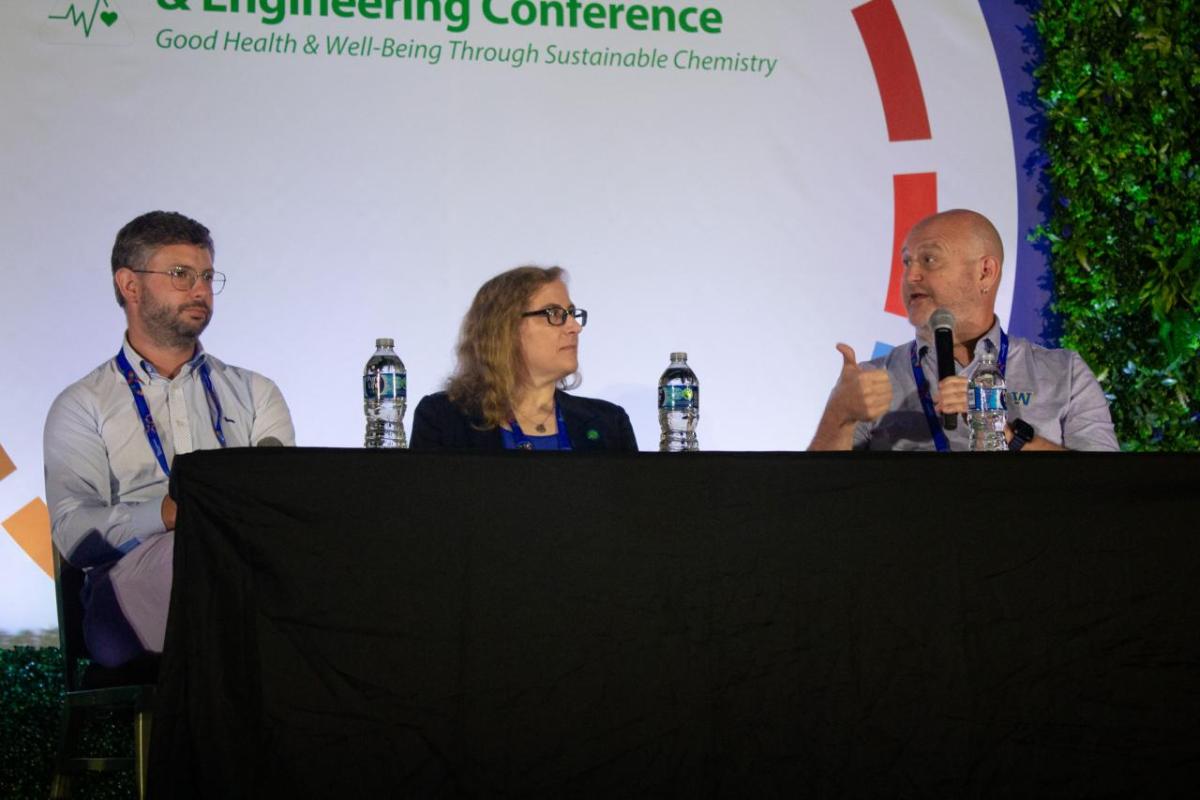 Three chemistry professors on stage at the Annual Green Chemistry and Engineering Conference