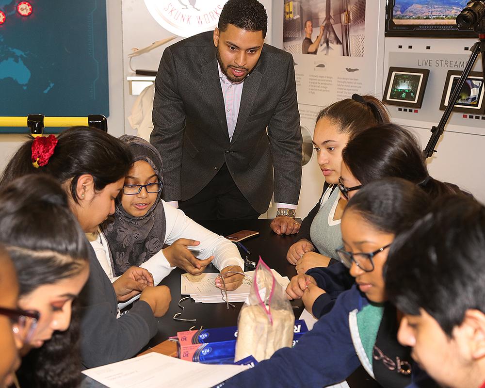Miguel Lopez, Lockheed Martin engineer and Central High alum, helps students with STEM project.