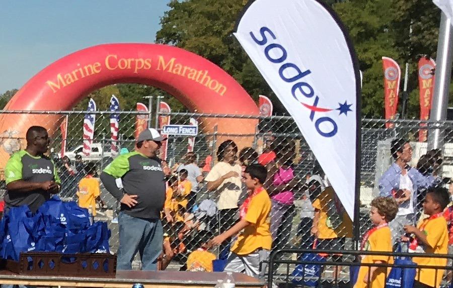 Sodexo team members hand out bags with a healthy and nutritious lunch to young runners completing the 2017 Marine Corp Marathon Kids Run. Sodexo, a food service and facilities management company focused on Quality of Life, has proudly supported the MCM Kids Run since 2003.