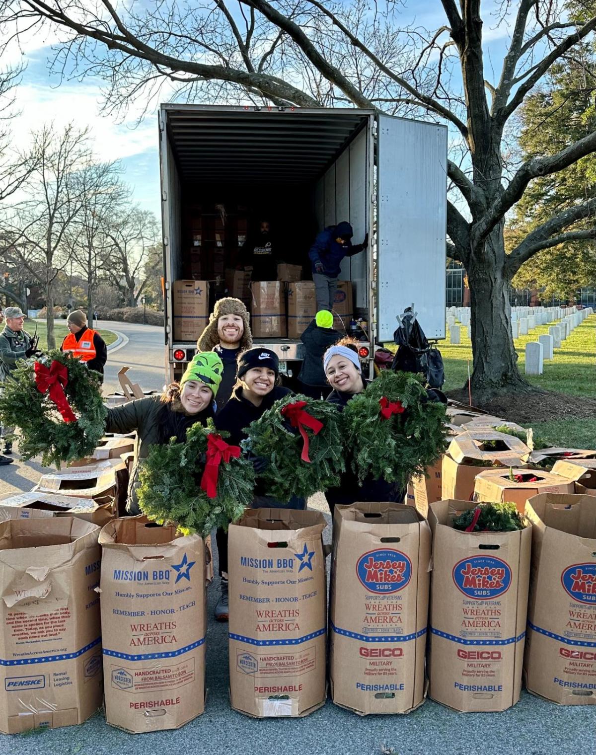 people holding up wreaths