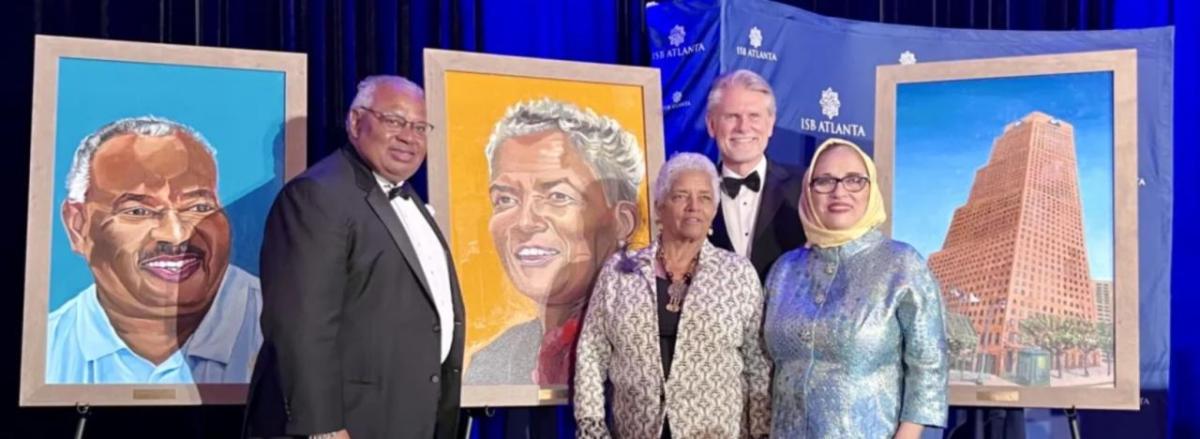 People stood near artwork at the annual ISB Celebrating Diversity & Inclusion Gala