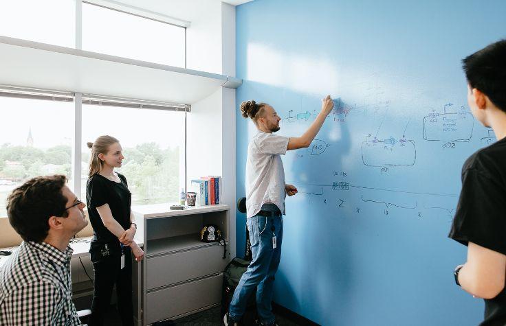 VP of Synthetic Biology Michael Köpke draws up the genetic circuit, with LanzaTech scientists Alex Mueller and Laura Cook.