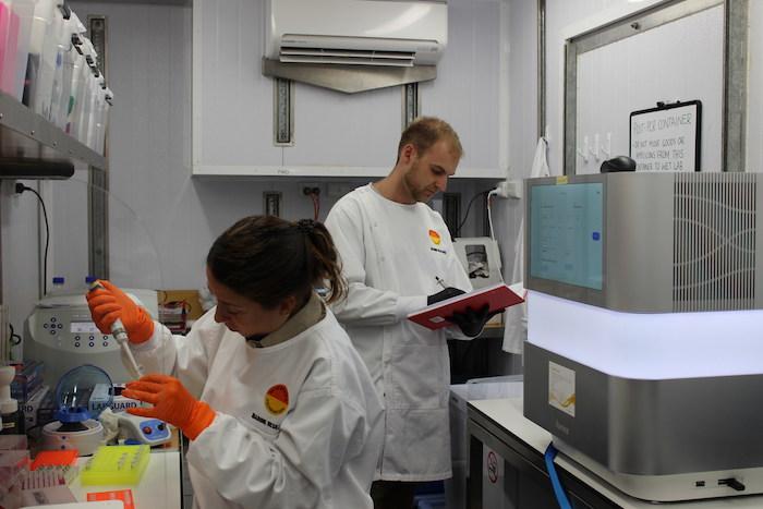 Two workers in a genomics lab.