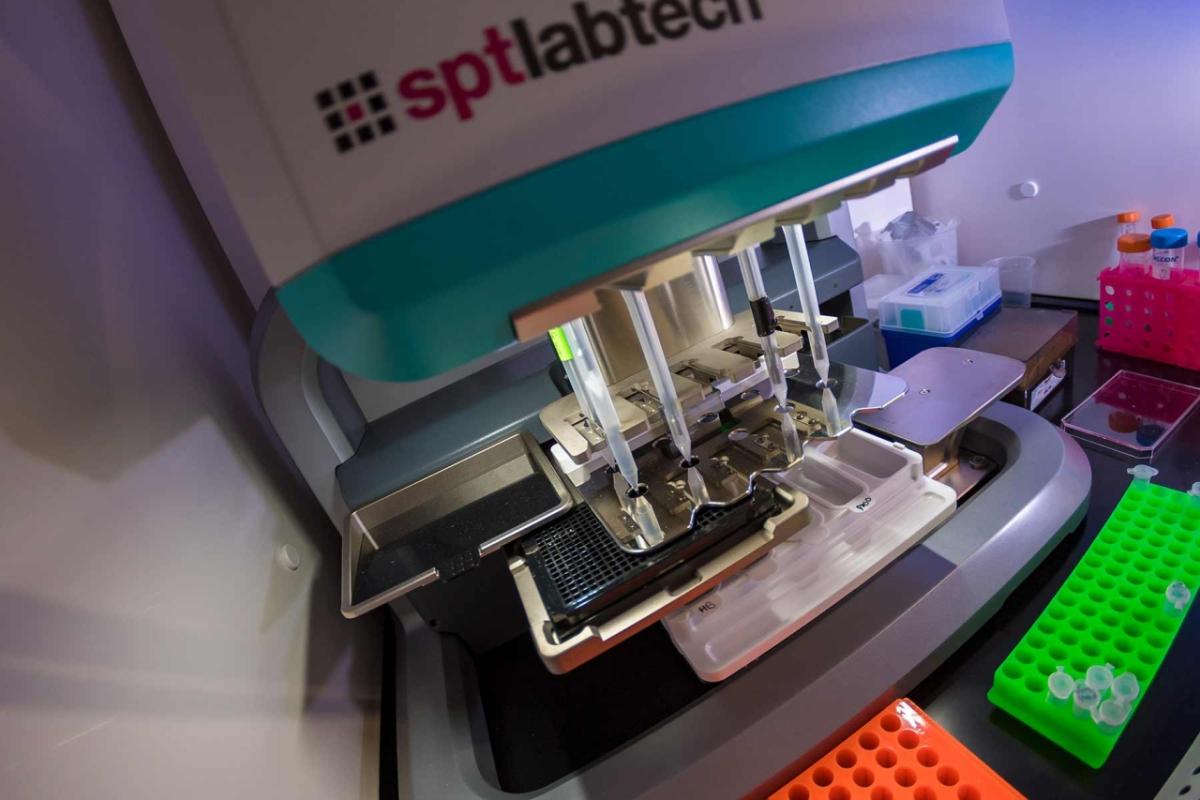 A pipetting robot dilutes samples into a plate for imaging in the Illumina Laboratory in Hubbs Hall.