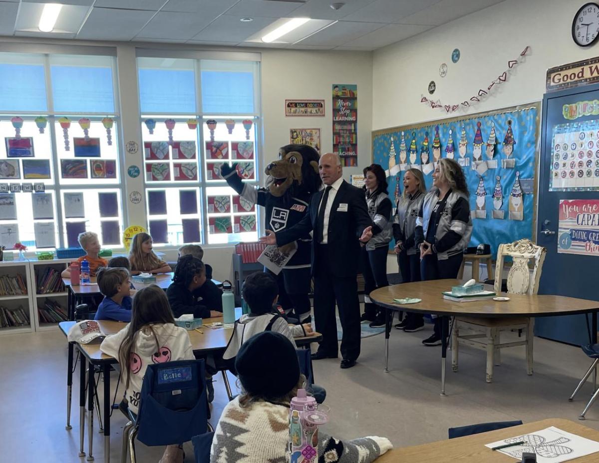 LA Kings Alumn and radio analyst Daryl Evans, the LA Kings Ice Crew and mascot Bailey greets students in Los Angeles, CA for Read Across America Day.