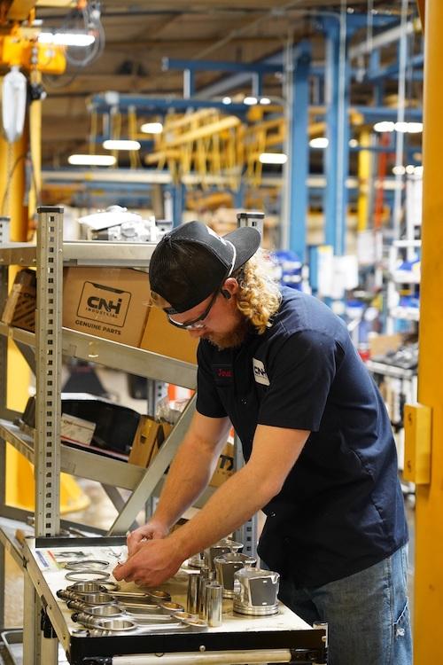 Person stood at a table of products for remanufacturing 