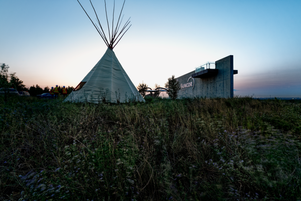 Teepee in front of sunset sky