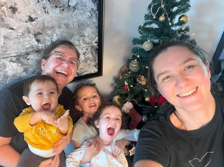 Cécile Vivares shown with her wife and three children in front of the family Christmas tree.