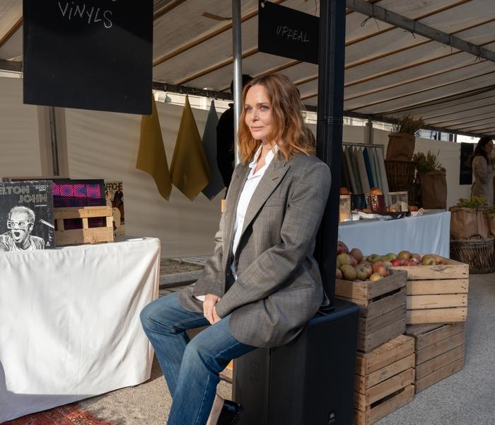 Designer Stella McCartney shown seated on a JBL Speaker in her Sustainable Market.