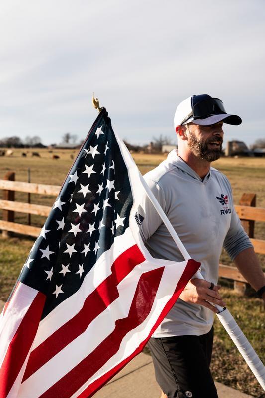 Jason Wood carrying flag