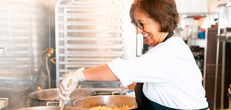 Person cooking over multiple pots