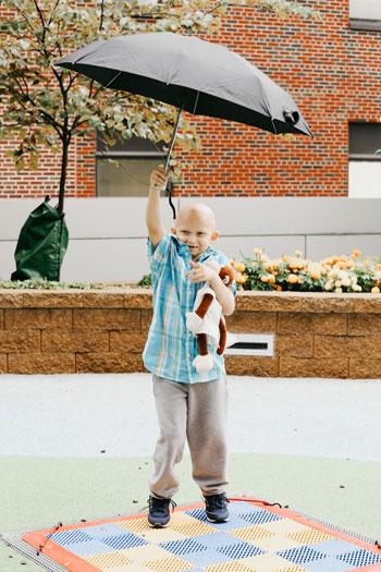Jens plays outside of the Helen DeVos Children’s Hospital. His stuffed monkey, Ivy, is his well-loved travel buddy.