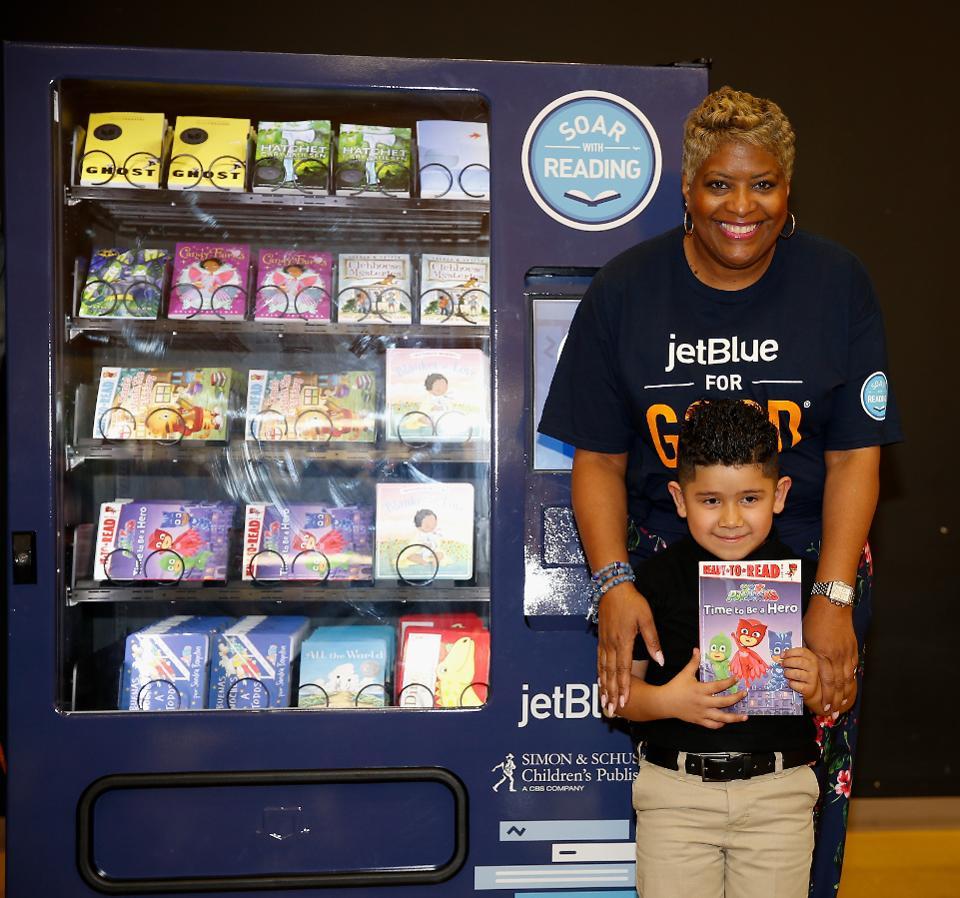 Icema Gibbs, director of corporate social responsibility at JetBlue, unveils 'Soar with Reading' free book vending machine in Houston | GETTY IMAGES FOR JETBLUE