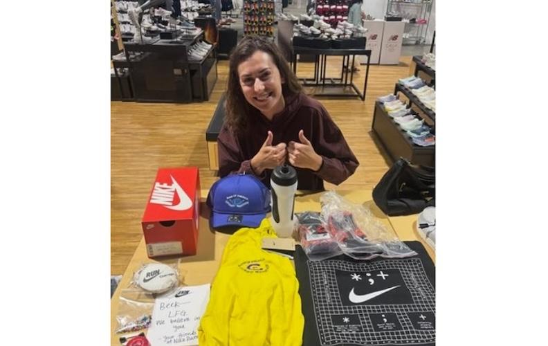 Nike’s Jo Dearman with Sabik’s marathon care package, including his extra prosthetic attachments.