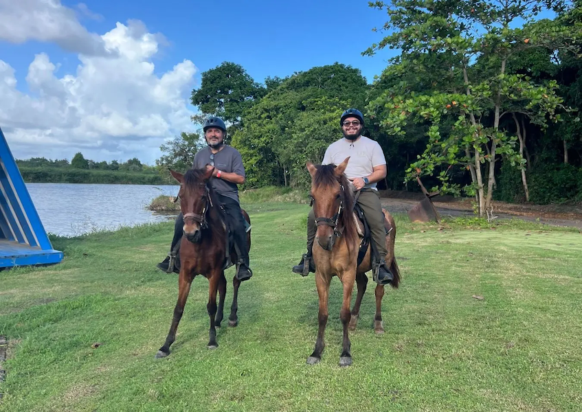 Jonathan with a friend riding horses.