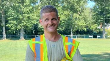 Jonathan Harmon, wearing a safety vest outside