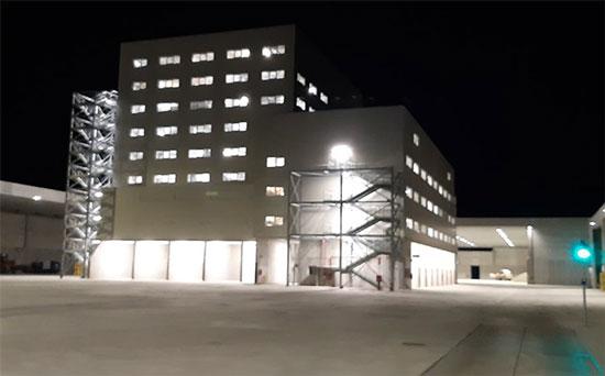 The Julia Vitrum Cullet Treatment plant in Italy is one of our creative, innovative and collaborative solutions. building lit up in the dark