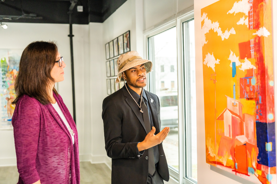 Two people looking at art on the wall