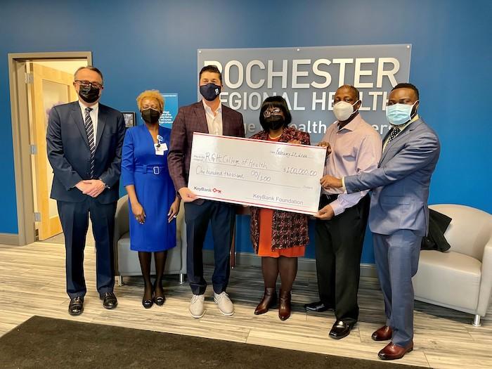 Rochester Regional Health accepts check for $100,00 from KeyBank. 