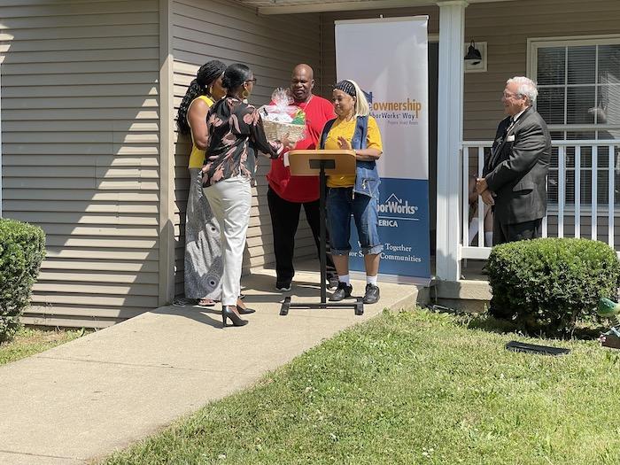 Photo: Cynthia and Larry Robinson are presented with gifts to celebrate their first home, financed by new loan program in city of Toledo.