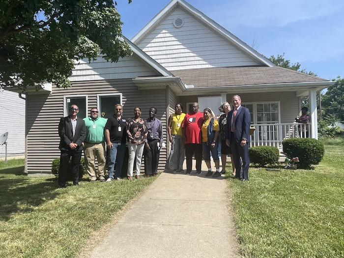  Representatives from KeyBank, NeighborWorks, The Fair Housing Center and City of Toledo gather in front of the Robinson family home to celebrate new loan program.