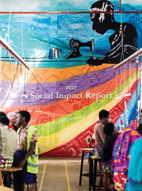 image of women sitting in rows at a sewing factory with a colorful wall in the background