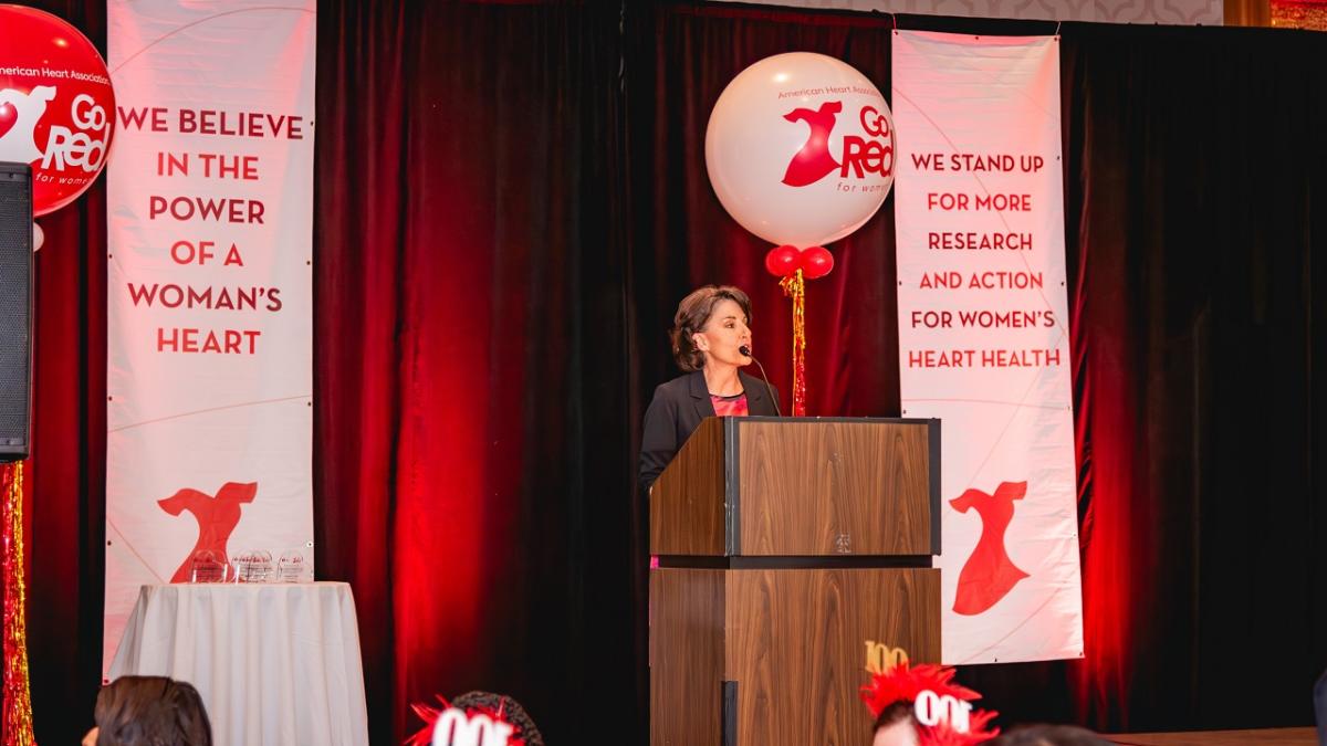 Kathryn Collins speaking at a podium.