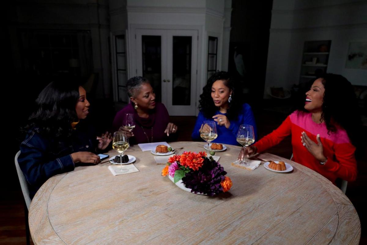 QVC Hosts Vanessa Herring, Jayne Brown, Monifa Days and Stacey Rusch are seated at a table while on-set at QVC Studios.